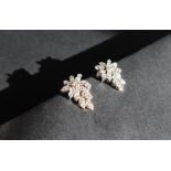 A pair of diamond drop earrings of leaf shape,