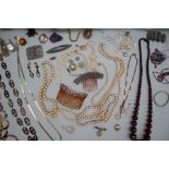 Assorted costume jewellery including faux pearls, hair combs, beaded necklaces, wristwatches,