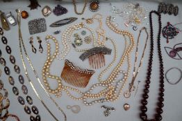 Assorted costume jewellery including faux pearls, hair combs, beaded necklaces, wristwatches,