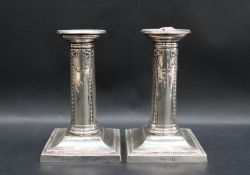 A pair of Edward VII silver desk candlesticks, with beaded rim,