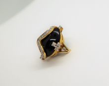 A diamond and cabochon onyx dress ring,