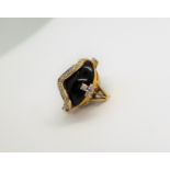 A diamond and cabochon onyx dress ring,