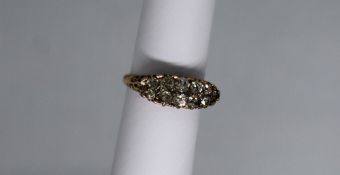 A diamond cluster ring set with two rows of old round cut diamonds to a white metal setting and