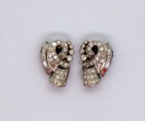 A pair of diamond encrusted earrings, set with round brilliant and baguette diamonds,