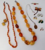 An amber bead necklace set with graduated clear and opaque beads to a lobster clasp,