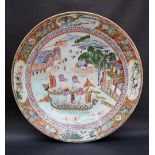A Chinese porcelain charger the centre painted with Dragon head boats,