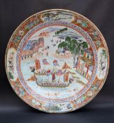 A Chinese porcelain charger the centre painted with Dragon head boats,