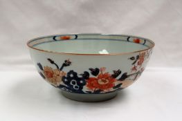 A Chinese porcelain bowl, painted with large flowerheads and leaves,