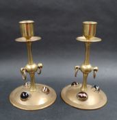 A pair of brass candlesticks,