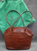 A Mulberry brown leather faux crocodile handbag together with a similar purse with a box for the