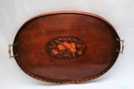 An Edwardian mahogany twin handled gallery tray of oval form,