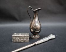 A late Victorian miniature silver ecclesiastical ewer, on a spreading foot,