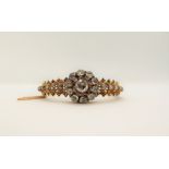 A Victorian diamond encrusted hinged bangle, set with rose cut diamonds to a yellow metal setting,