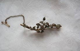 A yellow and white metal diamond set brooch of floral form, 6.5cm long, approximately 7.