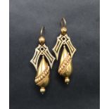 A pair of yellow metal drop earrings of pear shape with pierced and ball decoration