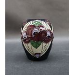 A Moorcroft pottery vase decorated with Art Nouveau inspired flowers and leaves to a grey ground,