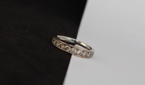 An 18ct white gold half eternity ring, set with fifteen round brilliant cut diamonds,