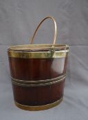 A 19th century mahogany peat bucket with brass strapping, liner and handle, 31.