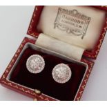 A pair of 18ct white gold baguette and round brilliant cut diamond set earrings of circular form,
