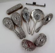 A pair of late Victorian silver backed clothes brushes, embossed with scrolling leaves, Birmingham,