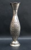 A Persian white metal repousse flared vase, with rope twist rim,