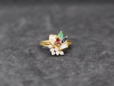 An 18ct gold diamond, ruby, sapphire and emerald dress ring, of floral design, size M,