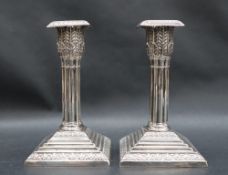 A pair of late Victorian silver desk candlesticks,