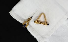 A pair of Boucheron of Paris yellow metal cufflinks of stirrup form with sugarloaf sapphire