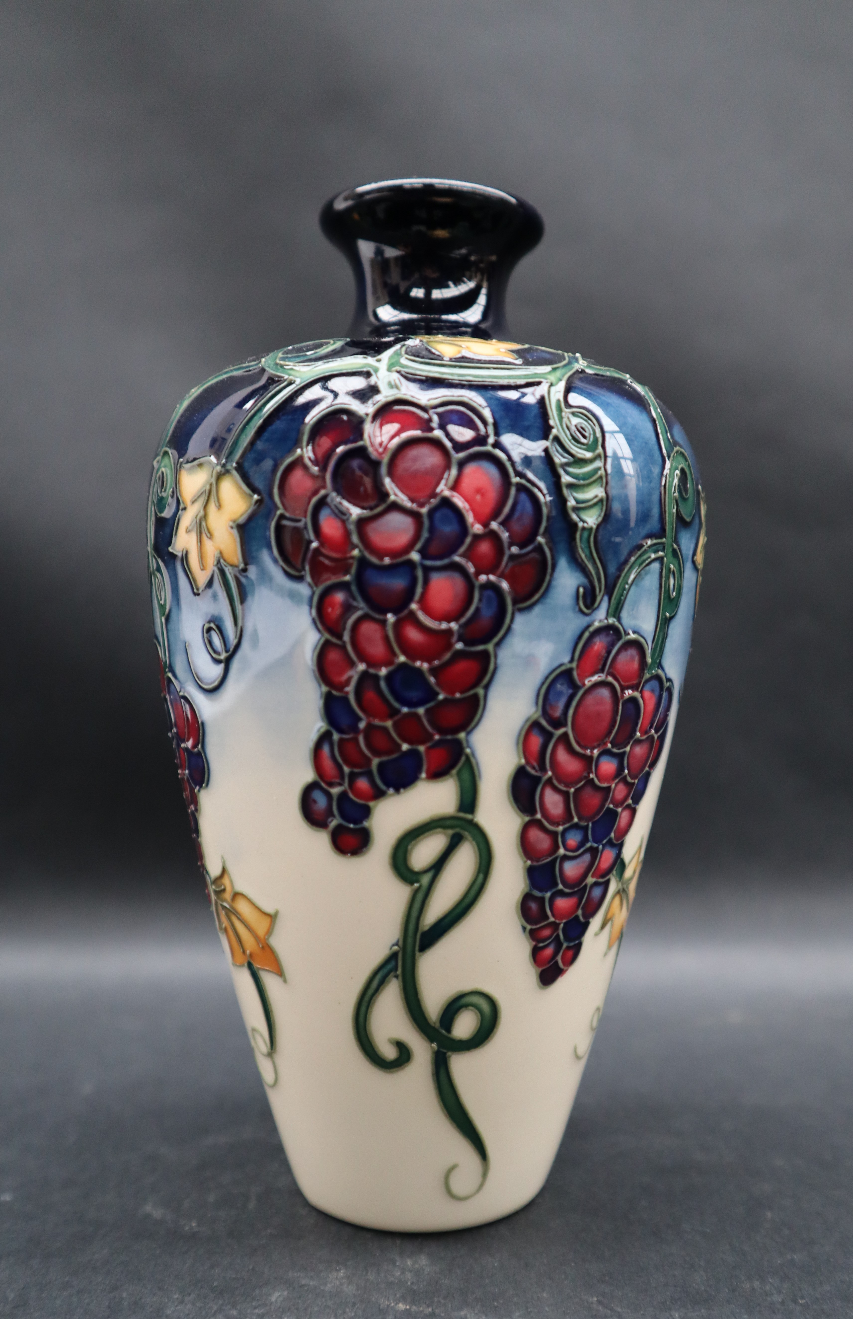 A Moorcroft pottery vase decorated with bunches of grapes and leaves to a cream ground, - Image 4 of 6