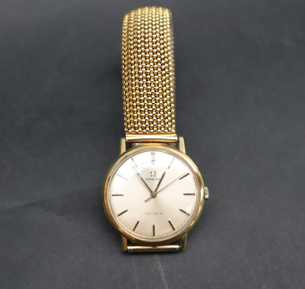A Gentleman's yellow metal Omega Geneve wristwatch, with a silvered dial and batons,