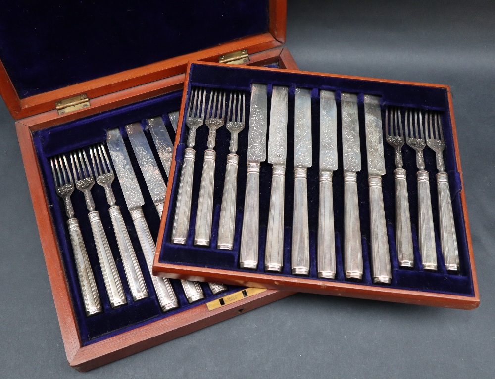 A late Victorian silver fruit set, with line decorated handles and leaf decorated blades and tines,