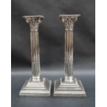 A pair of George V silver candlesticks,