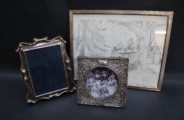 An Edward VII Art Nouveau silver photograph frame of square form, decorated with flowers and leaves,