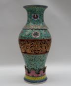 A Chinese porcelain two section vase, the flared top with turquoise ground and floral decoration,