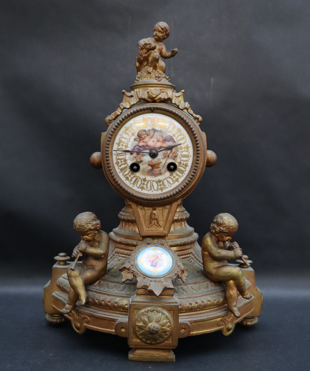 A 19th century French ormolu mantle clock, mounted with cherubs,