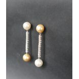 A pair of diamond and pearl drop earrings, set with a large yellow and white pearl,