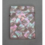 A mother of pearl card case of rectangular form, with geometric panels decorated with leaves,