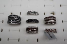 Gemporia - a silver ring set with five rows of black diamonds together with a collection of silver