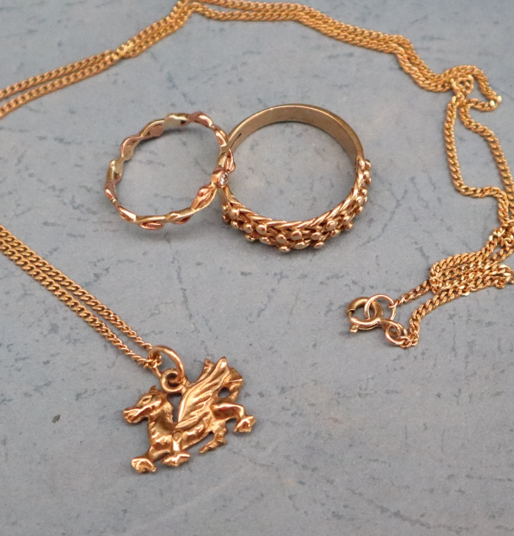 A 9ct yellow gold dragon pendant on a 9ct gold chain, together with a 9ct gold ring,