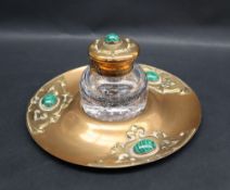 An Arts and Crafts desk inkwell of circular form set with malacite beads and raised decoration, 20.