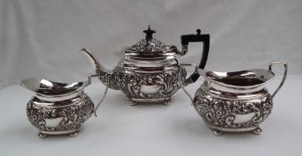 A late Victorian silver tea set, decorated with scrolling leaves and flowers, Birmingham, 1897,