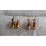 A pair of yellow metal drop earrings of pear shape with ball decoration,