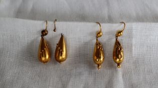 A pair of yellow metal drop earrings of pear shape with ball decoration,