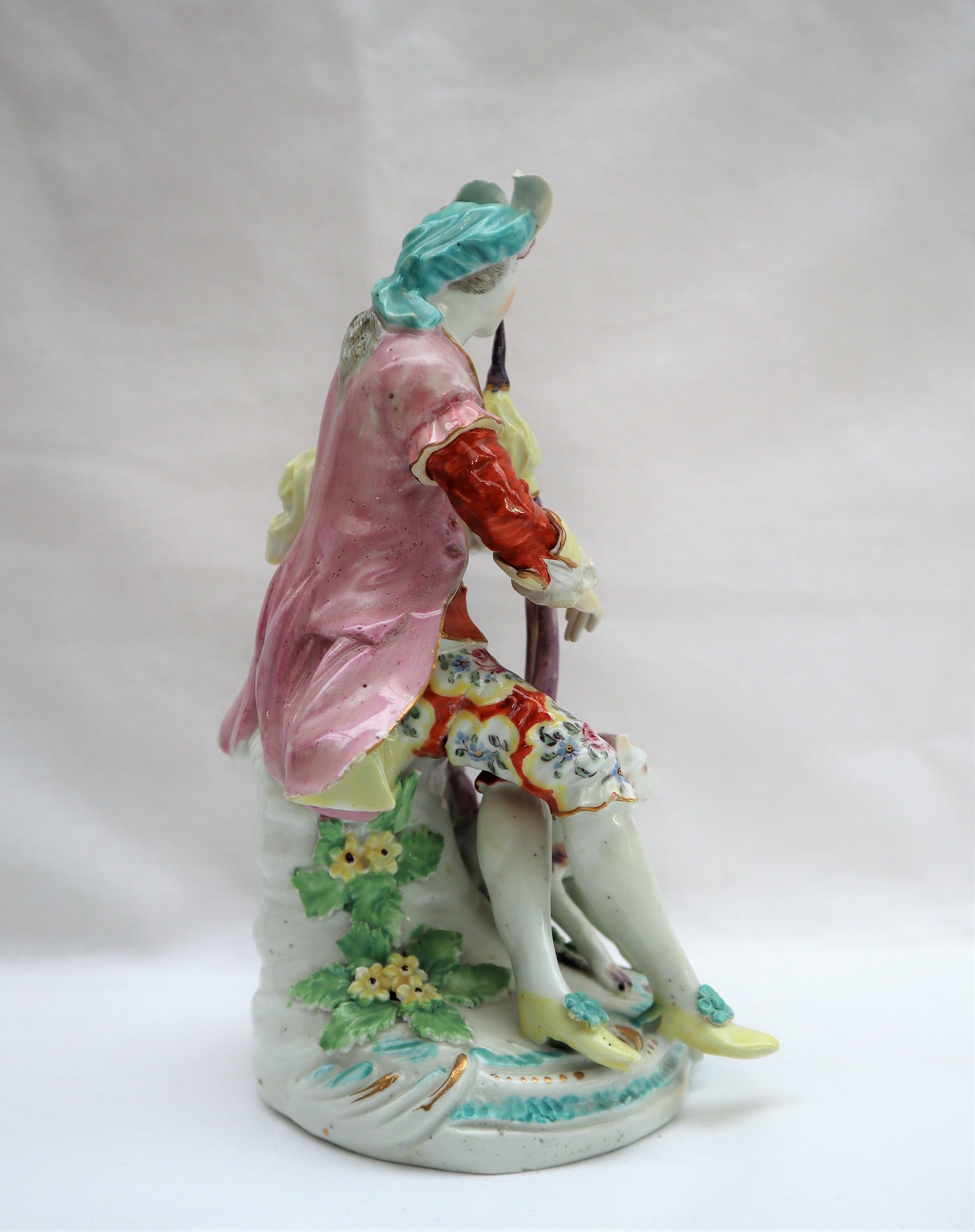 A Derby porcelain figure seated playing bagpipes with a dog at his feet on a circular base, 19. - Image 4 of 8