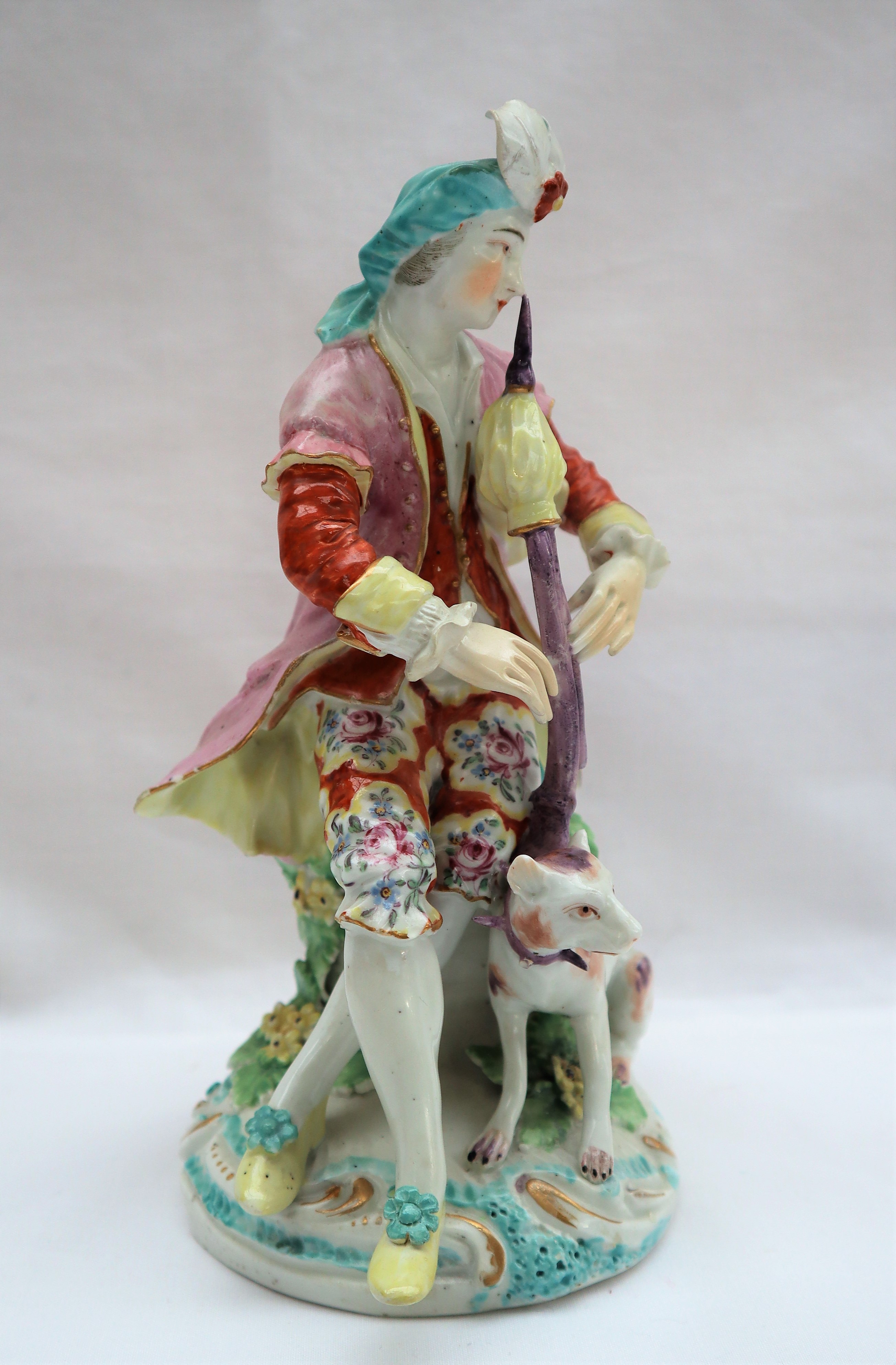 A Derby porcelain figure seated playing bagpipes with a dog at his feet on a circular base, 19. - Image 3 of 8