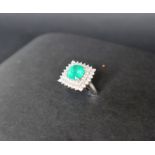 An emerald and diamond dress ring, the cushion cut emerald approximately 9mm x 9mm,