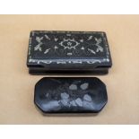 A papier mache snuff box of rectangular form inlaid with white metal birds, flowers and leaves,