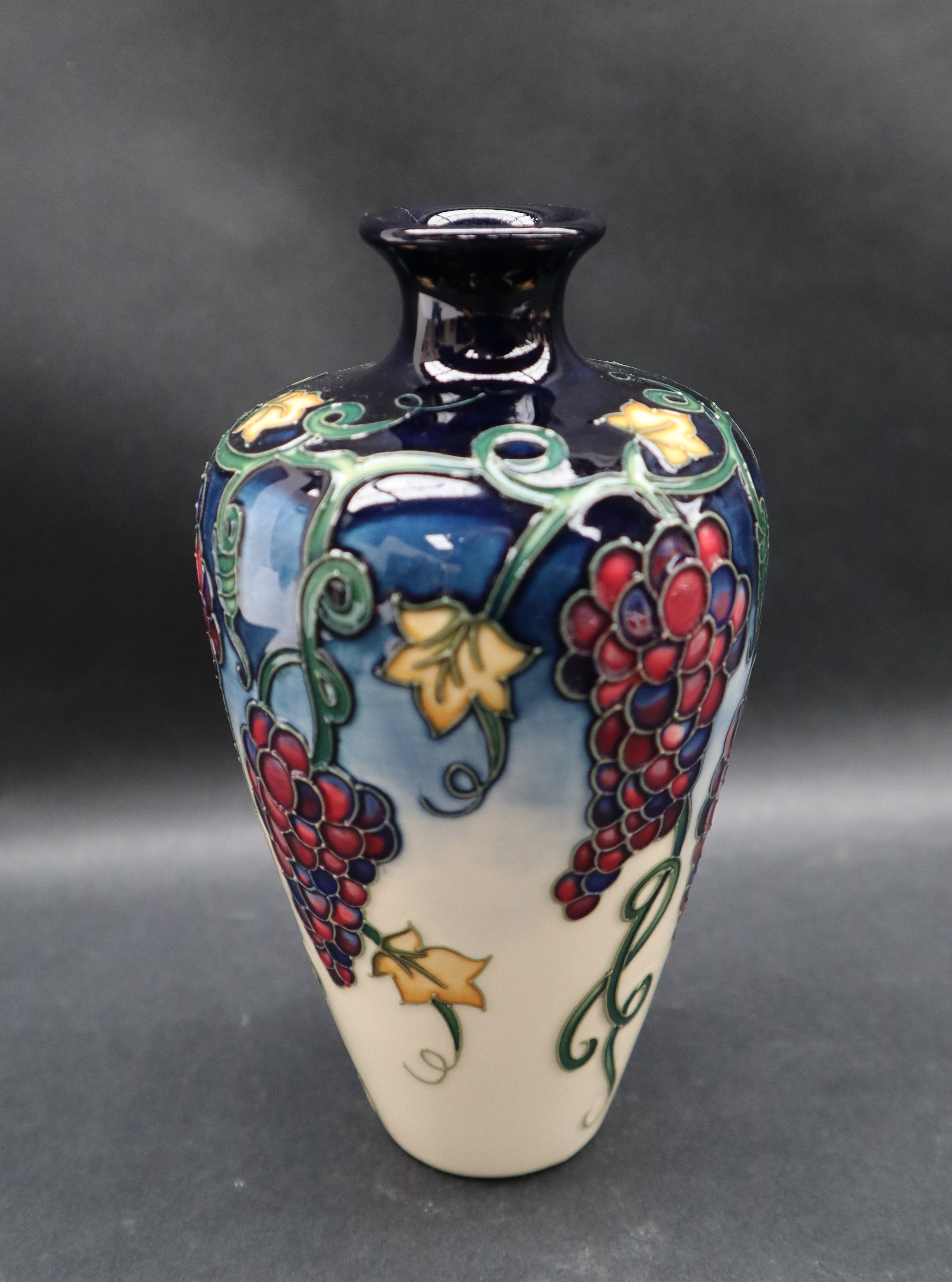 A Moorcroft pottery vase decorated with bunches of grapes and leaves to a cream ground, - Image 3 of 6