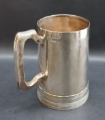 A George VI silver tankard of tapering cylindrical form with a line base and C handle, Sheffield,