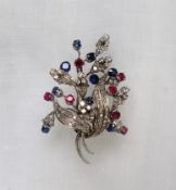 An 18ct gold diamond, ruby, and sapphire brooch of floral style, signed Chiappe,